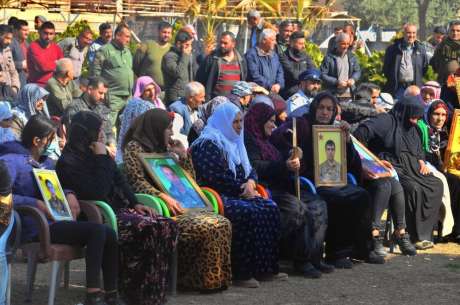 A commemoration of şehids in Til Temir, with mother carring pictures of their şehid sons and daughters